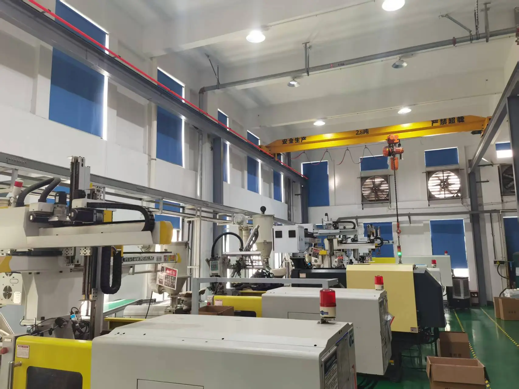 Large‑scale fully automated production machine manufacturing hearing aid accessories including wax guards, domes, tubes, earhooks, cleaning brushes, and dry boxes